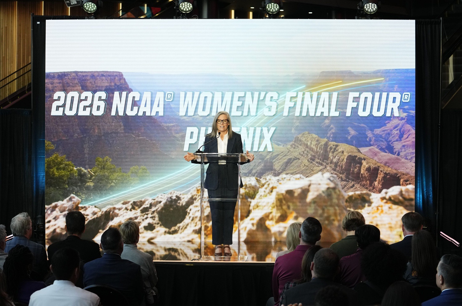 Gov. Hobbs in front of the 2026 NCAA Women's Final Four logo.