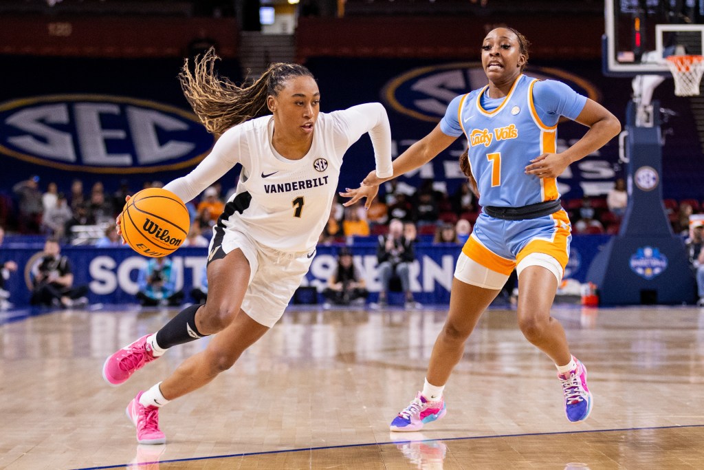 Vanderbilt guard Mikayla Blakes dribbles the ball with her right hand on the perimeter. A Tennessee defender is a few steps too late to stay with her.