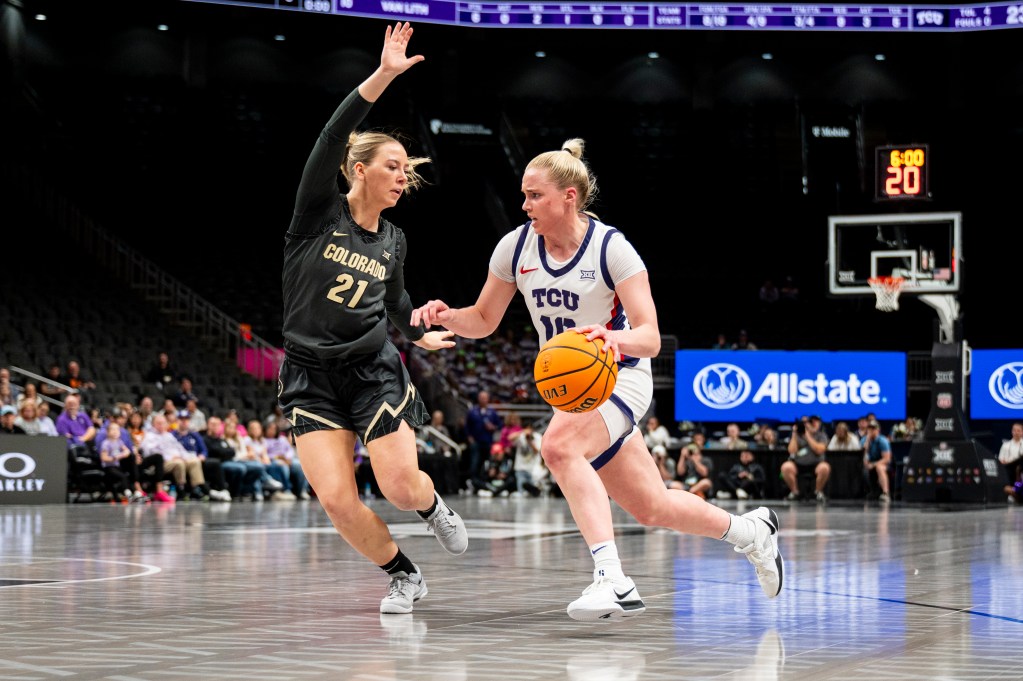 TCU guard Hailey Van Lith dribbles the ball with her left hand. Colorado guard Johanna Teder slides her feet to try to cut down Van Lith's driving angle.