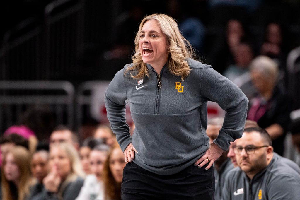 Baylor head coach Nicki Collen yells from the sideline with her hands on her hips.