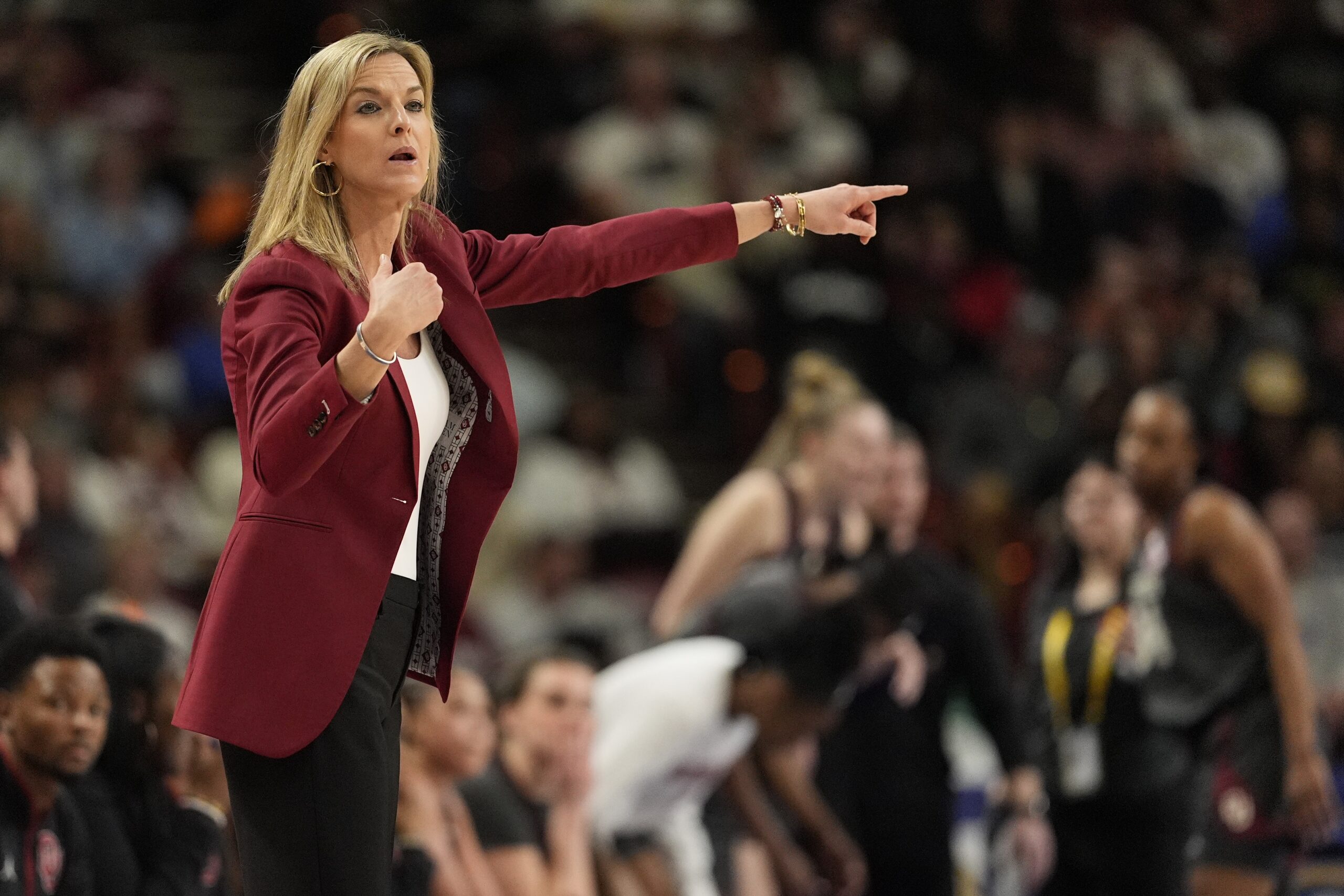 Photo of Oklahoma coach Jenny Baranczyk pointing to direct her team.