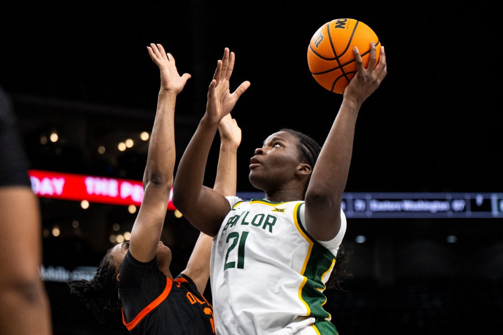Baylor Bears center Aaronette Vonleh (21) shoots the ball while Oklahoma State Cowgirls forward Praise Egharevba (24) defends with her arms up