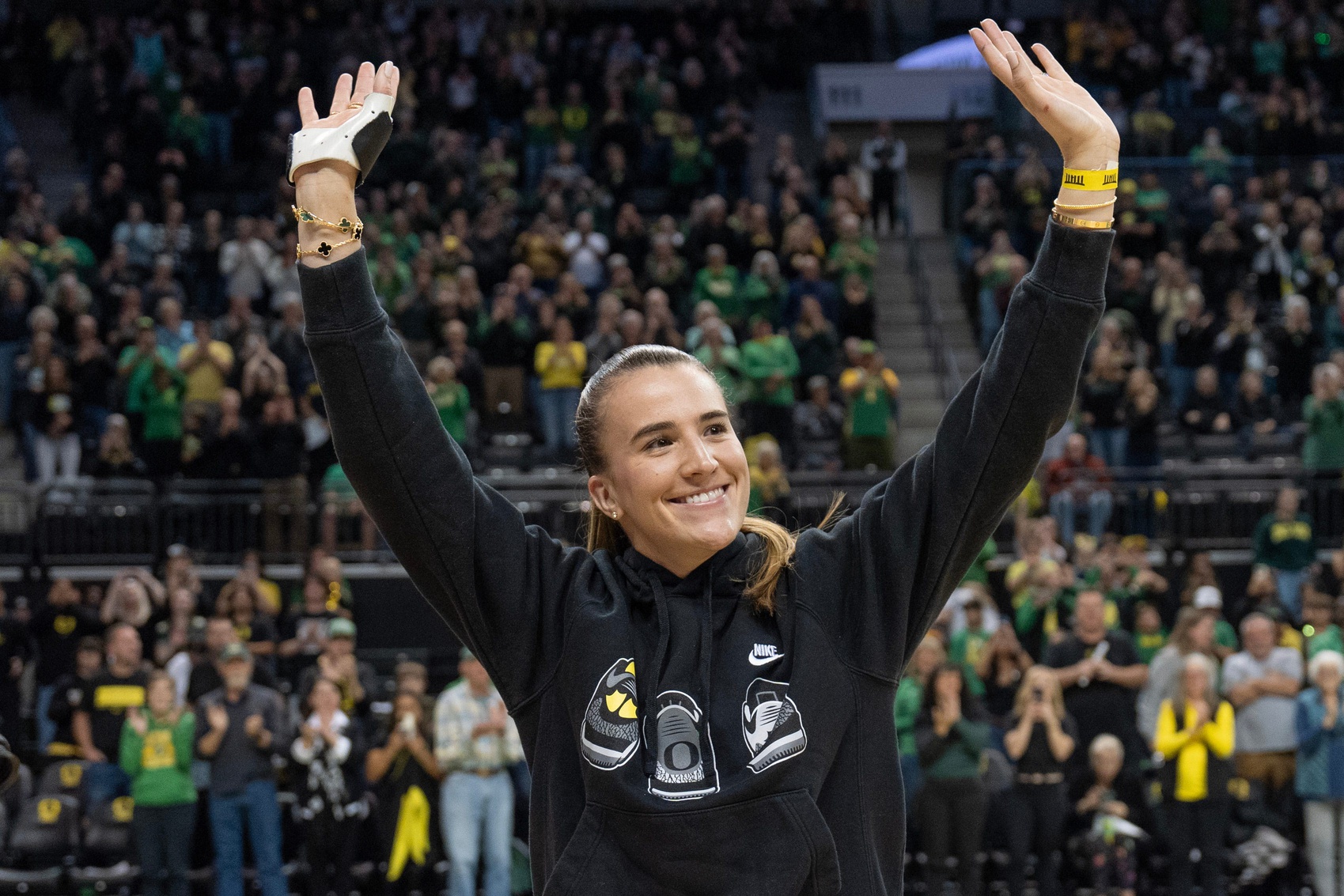 Sabrina Ionescu poses with WNBA trophy at Oregon game.