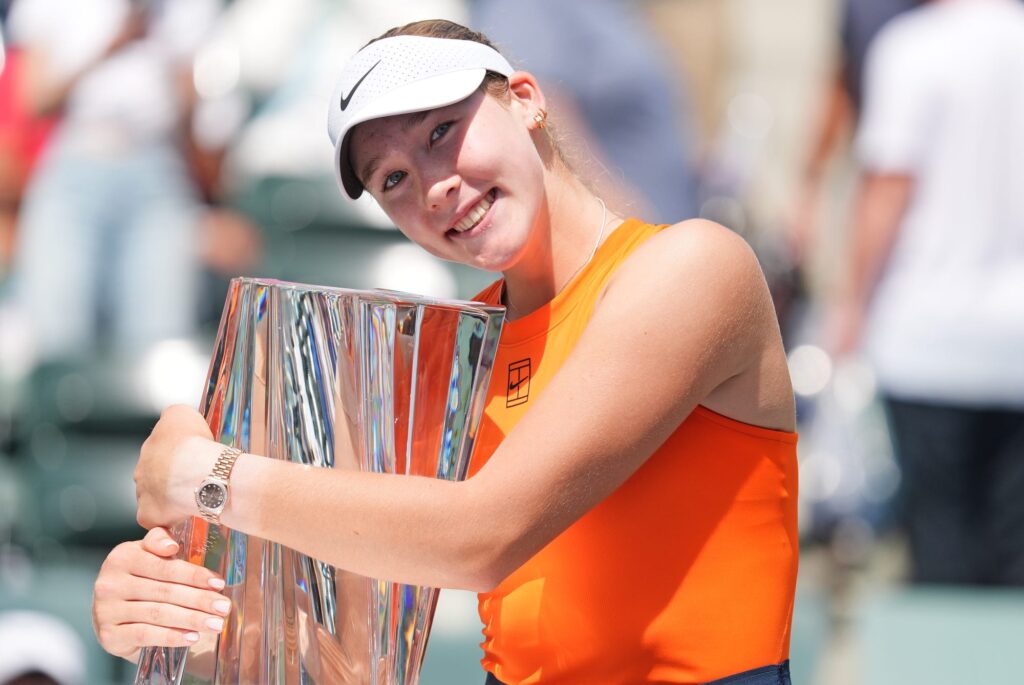 Mirra Andreeva hugs the trophy after capturing the 2025 BNP Paribas Open