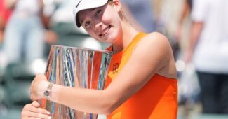 Mirra Andreeva hugs the trophy after capturing the 2025 BNP Paribas Open