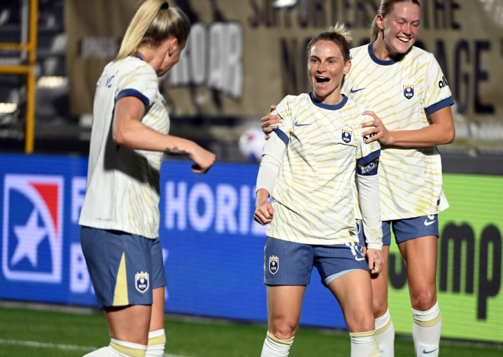 Seattle Reign midfielder Jessica Fishlock (10) celebrates with teammates after scoring during the first half against the North Carolina Courage at First Horizon Stadium at WakeMed Soccer Park in Cary, N.C., on March 22, 2025. (Photo credit: Rob Kinnan | Imagn Images)