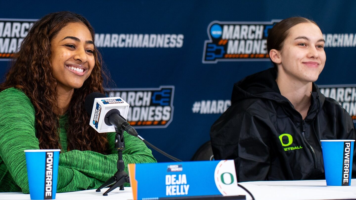Deja Kelly and Peyton Scott sit at a white table in front of a blue March Madness backdrop at Cameron Indoor Stadium in Durham, N.C. on March 21, 2025