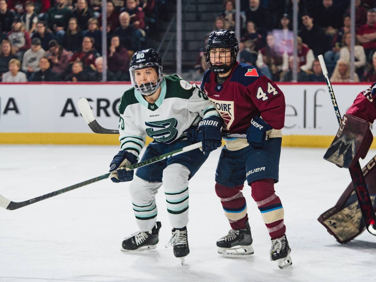 Brandt (left in white) and Boulier (right in maroon) battle for positioning just outside the crease.