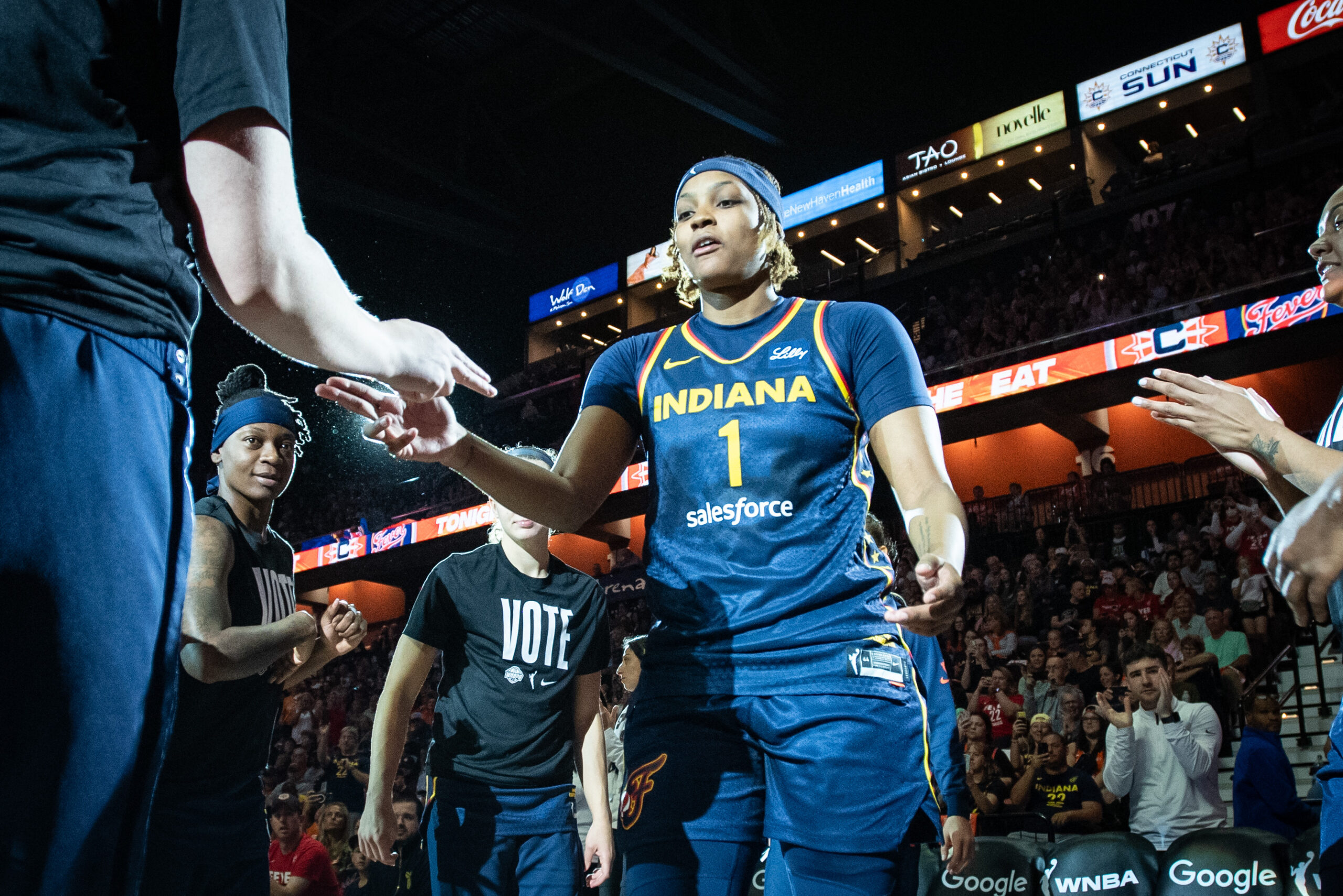 NaLyssa Smith high fives fans as she walks onto the court.