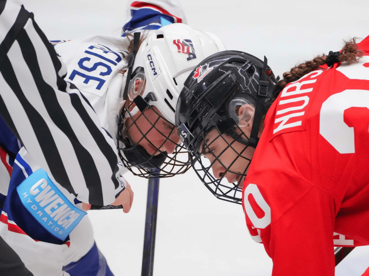 Heise and Nurse are both bent over, sticks on the ice. They're watching the puck as the ref prepares to drop it.