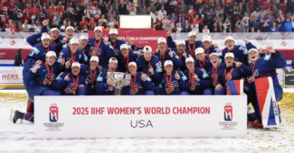 United States Women's hockey celebrating on the ice in their blue jerseys after winning the 2025 Women's World Championships