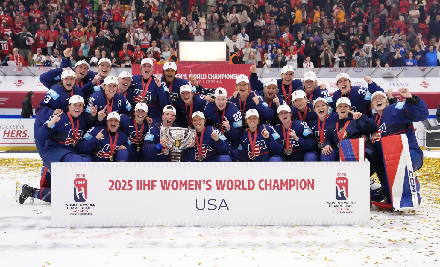 United States Women's hockey celebrating on the ice in their blue jerseys after winning the 2025 Women's World Championships