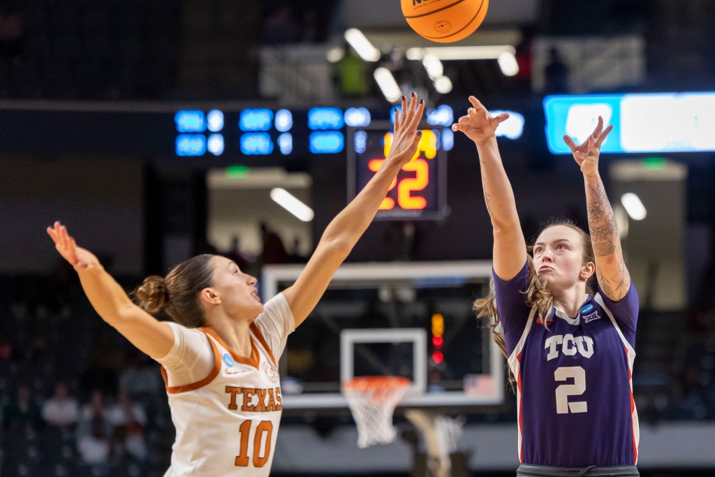 TCU Horned Frogs guard Madison Conner (2) shoots over Texas Longhorns guard Shay Holle (10) during the second half of an Elite Eight NCAA Tournament basketball game at Legacy Arena in Birmingham, Al. on March 31, 2025.