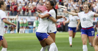 Trinity Rodman and Alyssa Thompson hug after a goal is scored