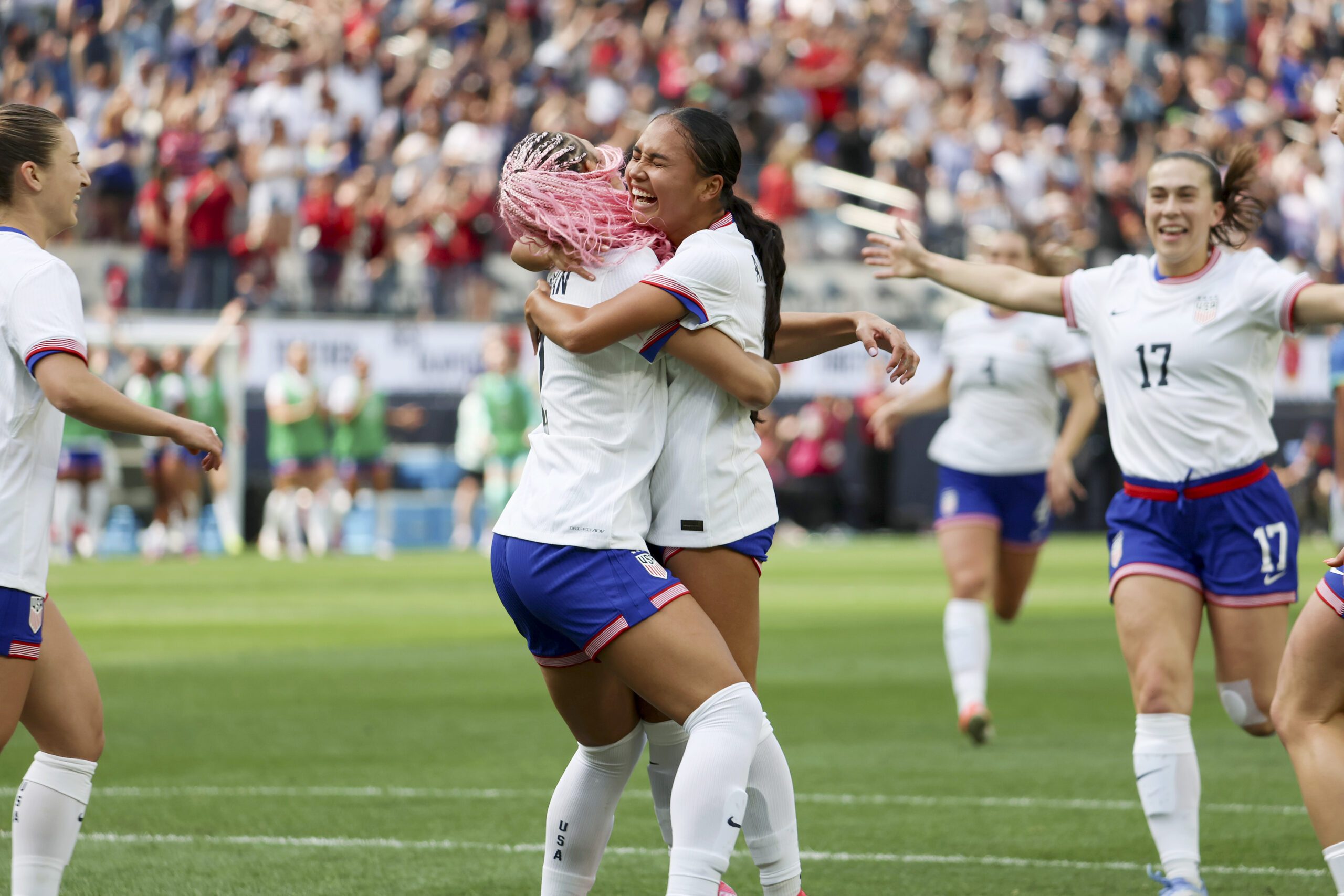 Trinity Rodman and Alyssa Thompson hug after a goal is scored