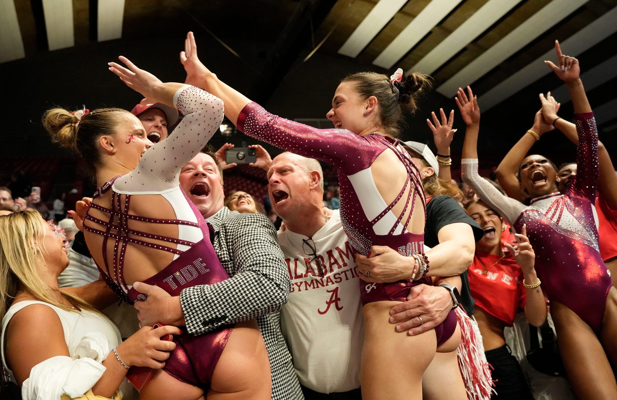 Alabama gymnasts celebrate with their dads after making it to the national championships.