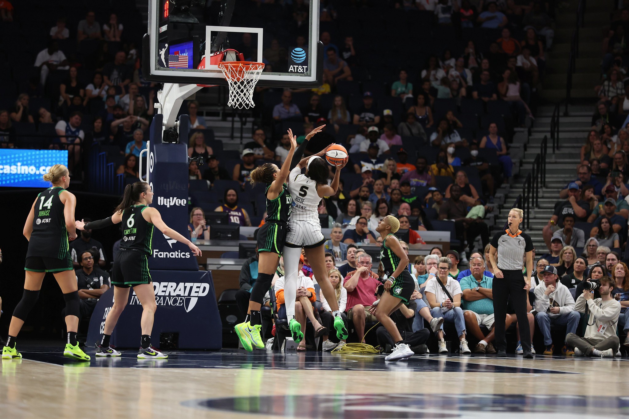 Chicago forward Angel Reese jumps and gets ready to shoot a right handed layup while Napheesa Collier tries to block it