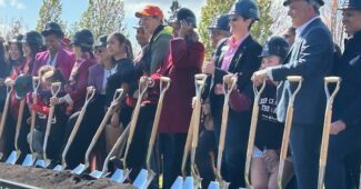 Several officials hold shovels as they break ground on a WNBA/NWSL training center in Portland, Oregon.