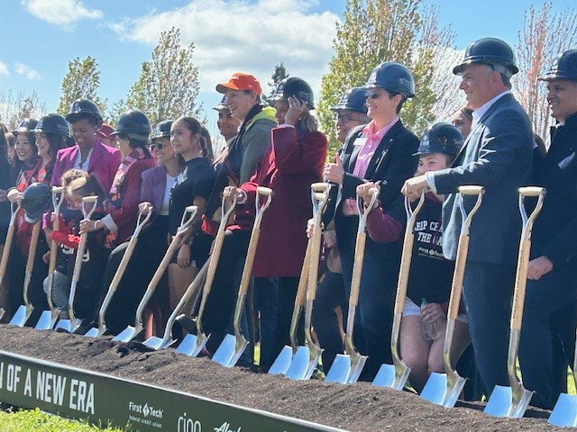Several officials hold shovels as they break ground on a WNBA/NWSL training center in Portland, Oregon.