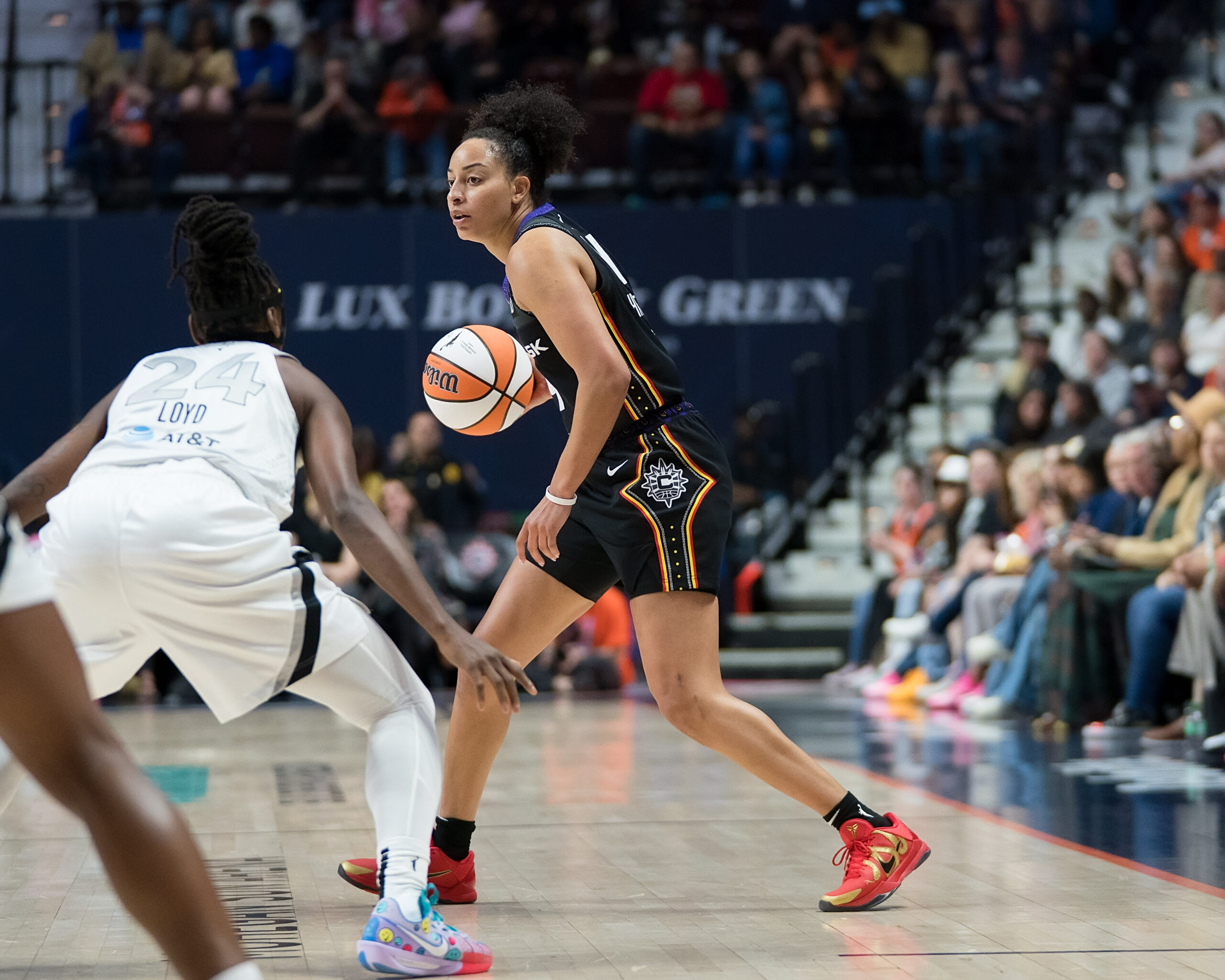 Bria Hartley dribbles basketball in a game.