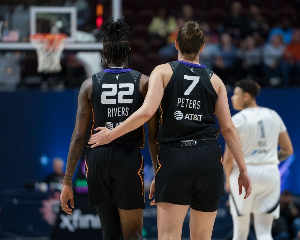 Haley Peters places her hand on Saniya Rivers back in support.