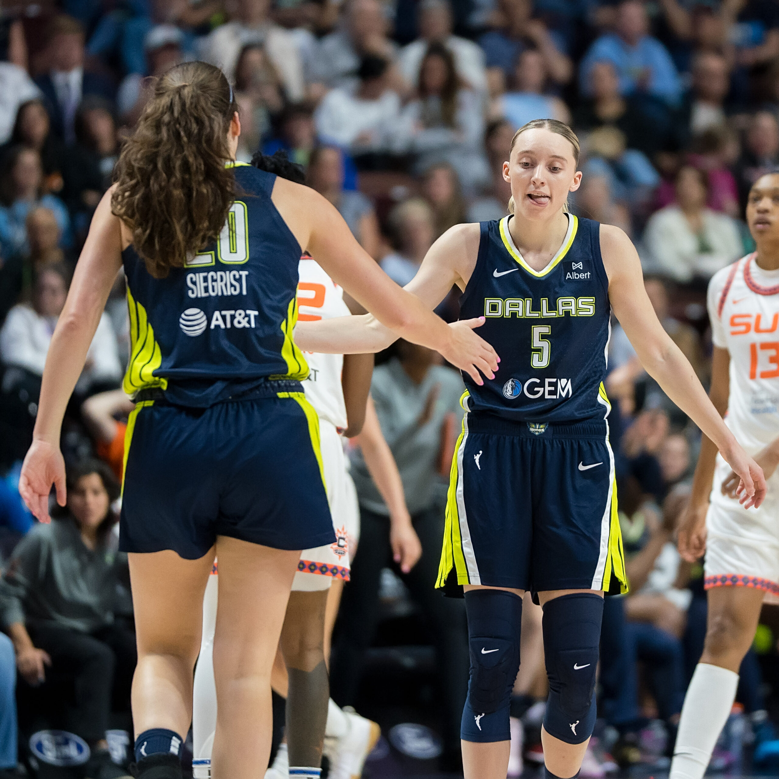 Dallas Wings guard Paige Bueckers high-fives teammate Maddy Siegrist