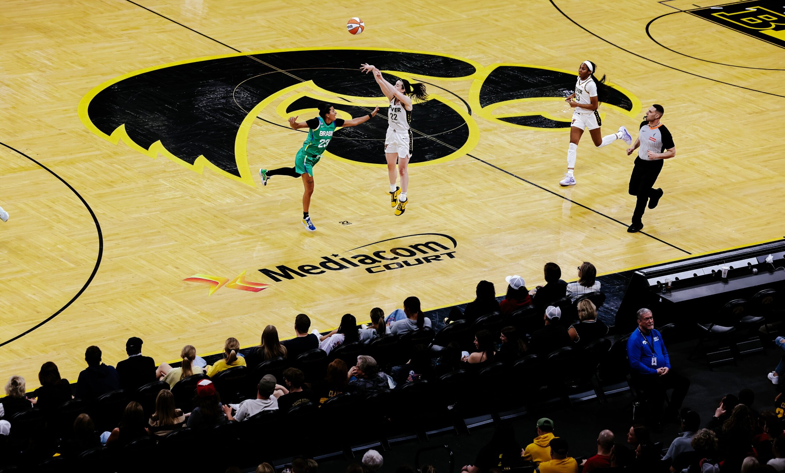 Indiana Fever guard Caitlin Clark shoots logo 3-pointer at Carver-Hawkeye Arena.