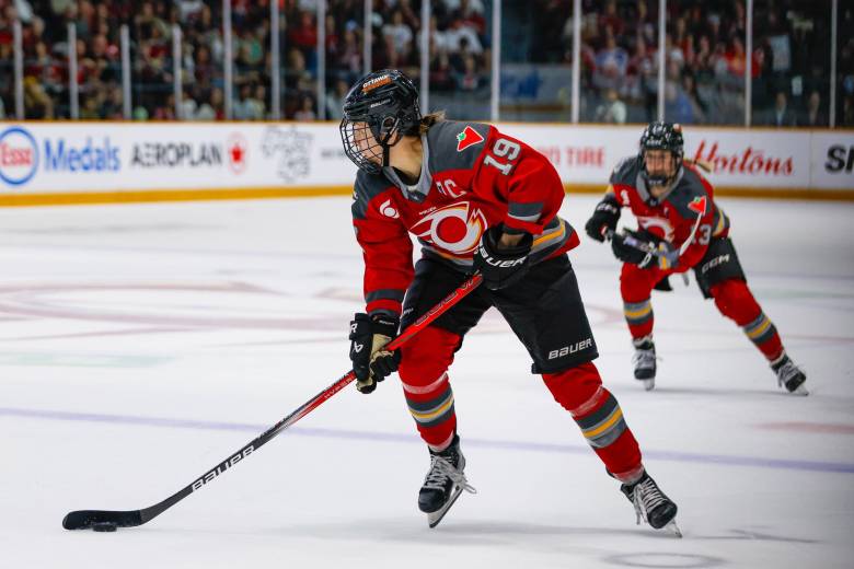 Brianne Jenner carries the puck into the z