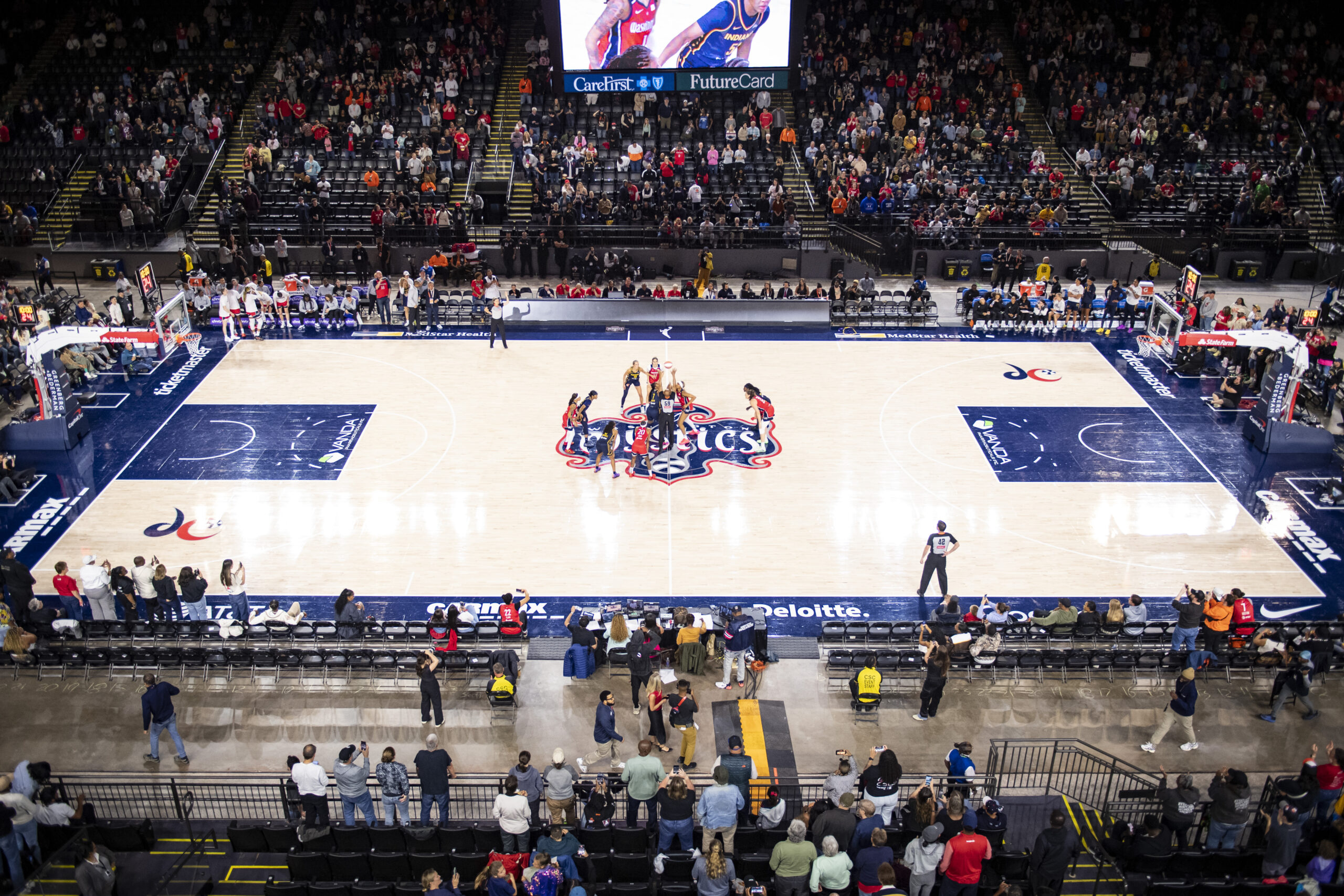 The Washington Mystics and the Indiana Fever prepare for the opening tip at Baltimore's CFG Bank Arena.