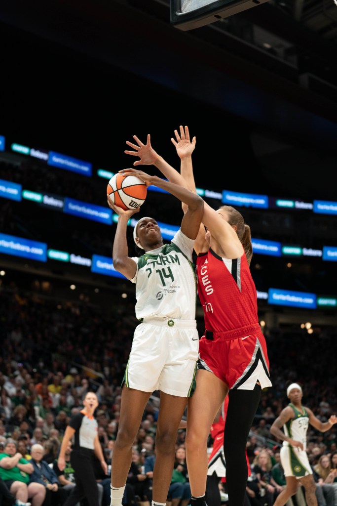 Seattle Storm forward Dominique Malonga tries to force the ball up into the basket against Las Vegas Aces forward Elizabeth Kitley in a game on May 25, 2025 at Climate Pledge Arena in Seattle, Wash.