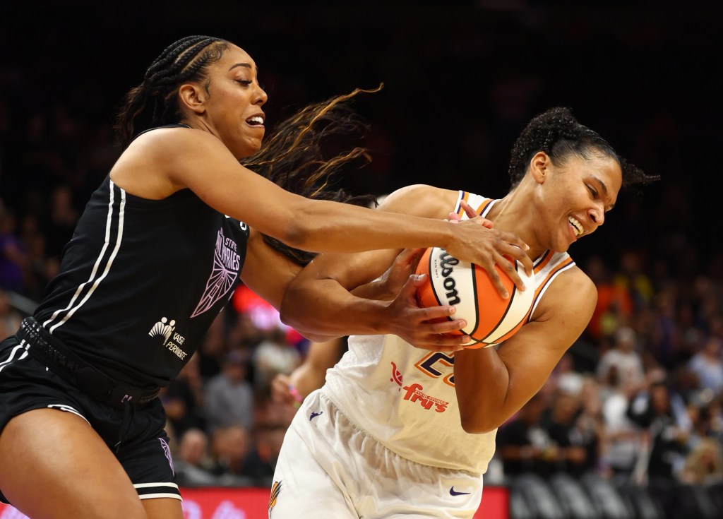 Alyssa Thomas (right) holds onto the ball, trying to pull it away from Monique Billings (left)
