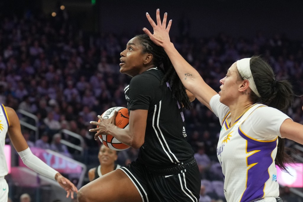 Golden State Valkyries guard Tiffany Hayes drives against Los Angeles Sparks forward Dearica Hamby