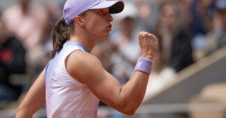 Iga Swiatek fist pumps in her 2025 Roland Garros opener.