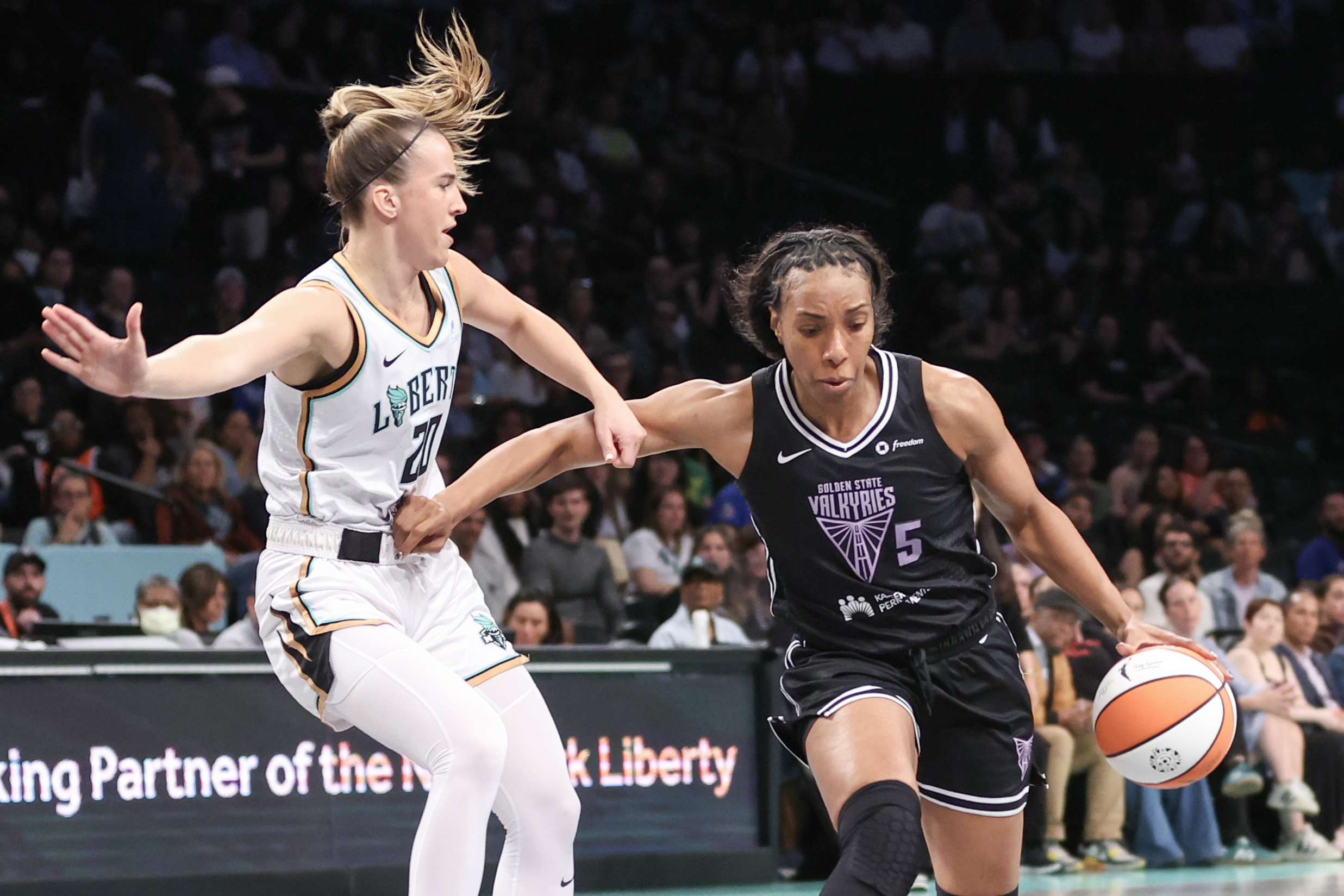 Kayla Thornton of the Golden State Valkyries drives past former teammate Sabrina Ionescu.