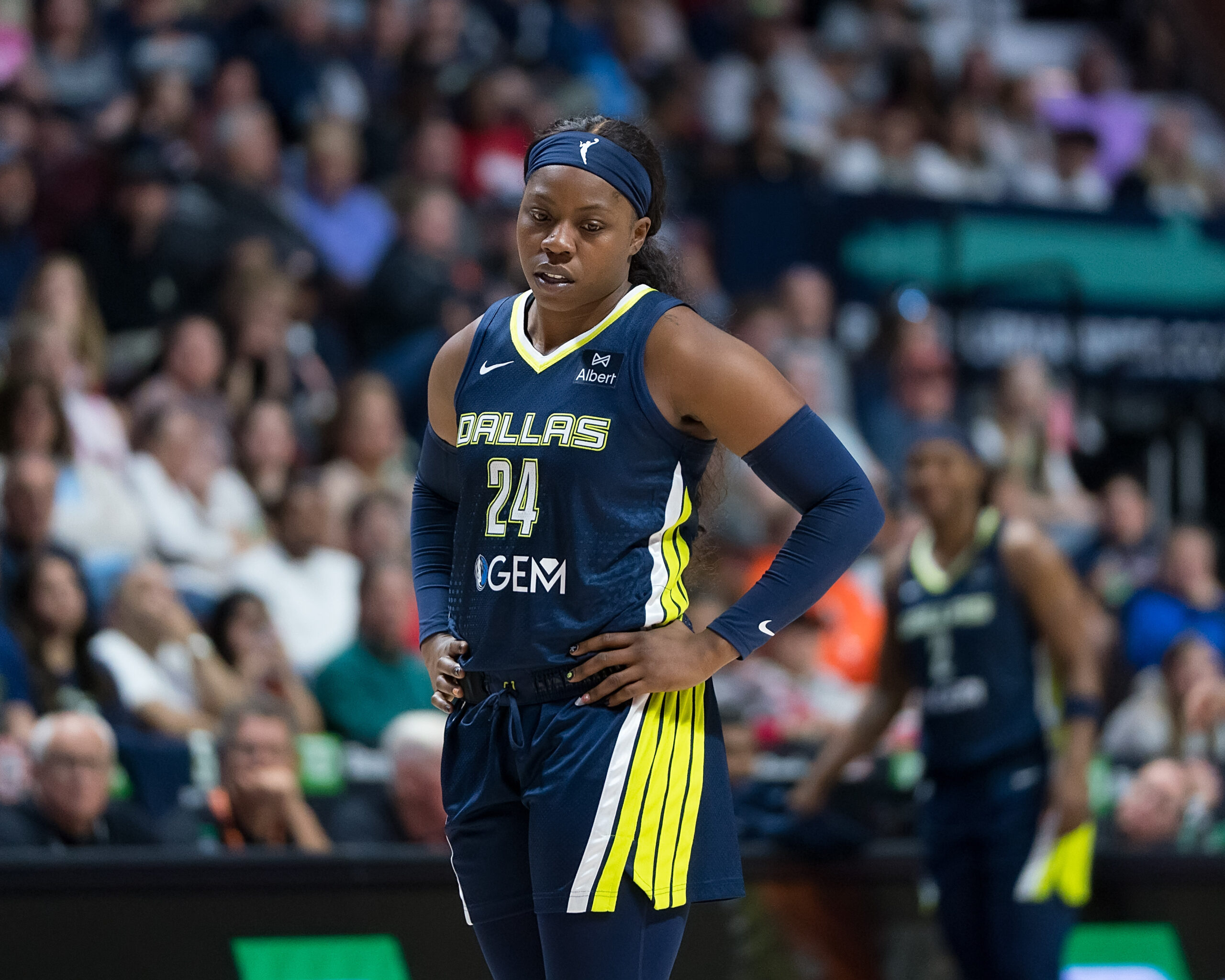 Dallas Wings guard Arike Ogubowale walks with her hands on her hips