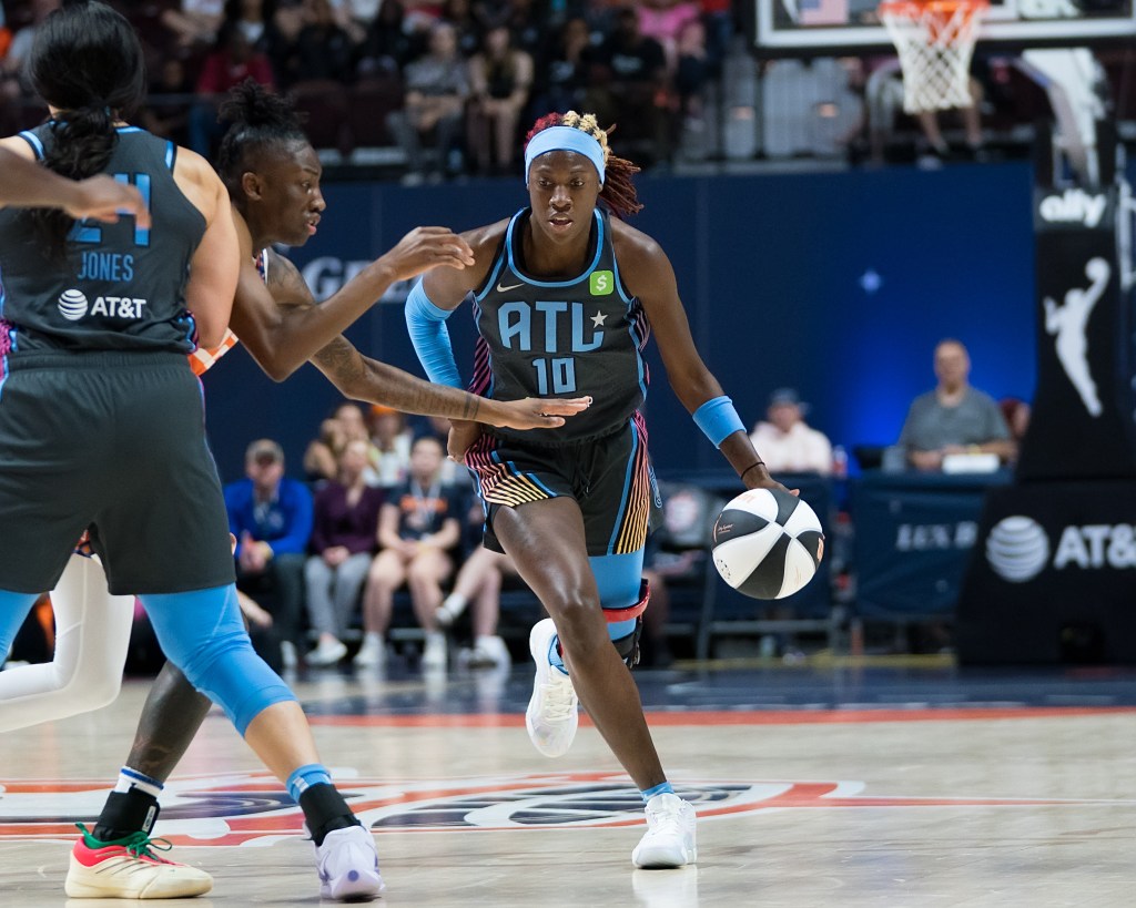 Atlanta Dream guard Rhyne Howard dribbles the ball with her left hand as forward <a rel=
