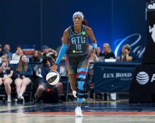 Atlanta Dream guard Rhyne Howard has her head up as she dribbles the ball with her right hand.