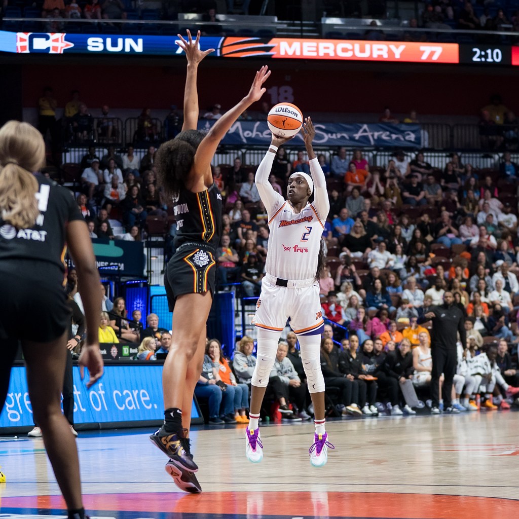 Phoenix Mercury guard/forward Kahleah Copper shoots the ball over Connecticut Sun center Olivia Nelson-Ododa, who attempts to block the shot with her left hand.