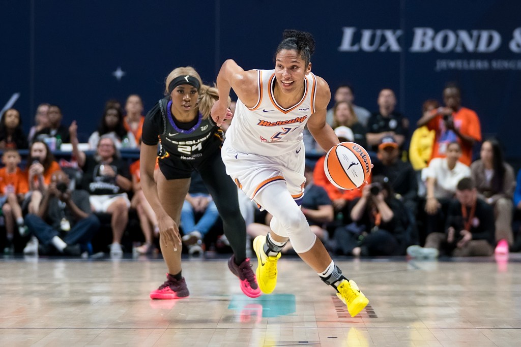 Alyssa Thomas dribbles the basketball as she drives towards the basket.