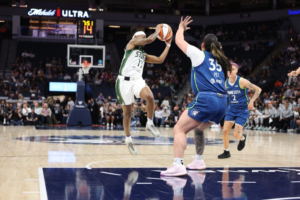 Seattle Storm guard Erica Wheeler looks to make a pass midair in a game against the Minnesota Lynx on May 27, 2025 at Target Center in Minneapolis, Minnesota.