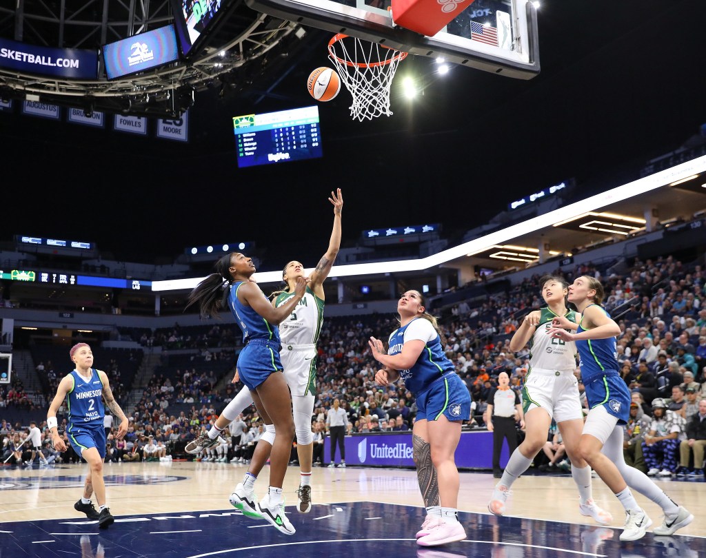 Seattle Storm forward Gabby Williams shoots in a crowded painted area against the Minnesota Lynx in a game on May 27, 2025 at Target Center in Minneapolis, Minnesota.