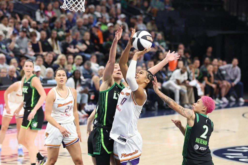 Satou Sabally (0) shoots a layup while Jessica Sheapard attempts to block and Nitsha Hiedeman defends her from behind