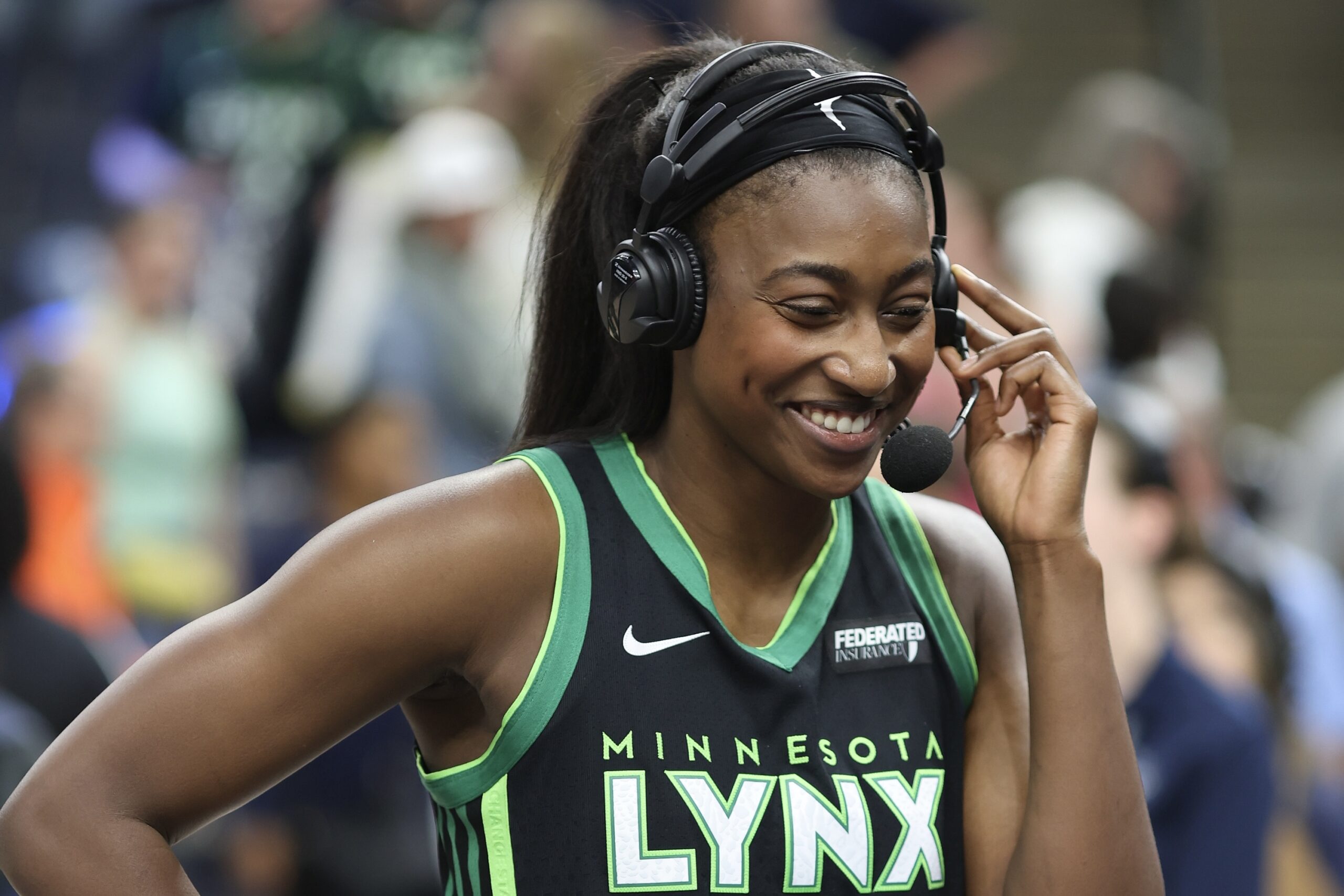 Diamond Miller smiles with a headset on