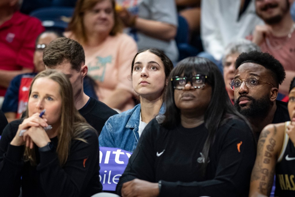 Washington Mystics guard Georgia Amoore sits in the second row on the Mystics' bench. She looks straight ahead, watching the action on the court.