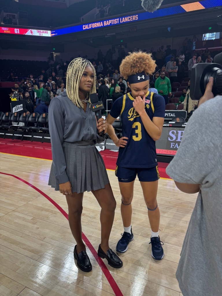 Isis Young prepares to interview Notre Dame guard Hannah Hildalgo by holding a microphone following her teams non-conference victory over USC in December 2024.