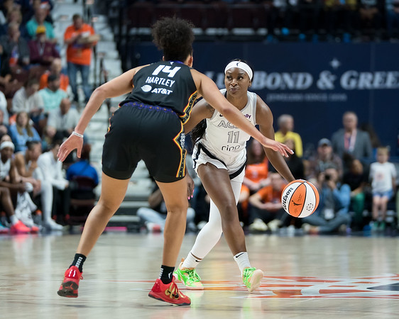 Las Vegas Aces guard Dana Evans faces off against Connecticut Sun guard Bria Hartley.