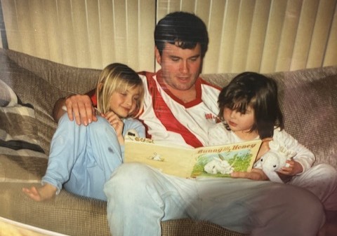 Megan Gustafson and her sister, Emily, read with their dad, Clendon, when they were younger.