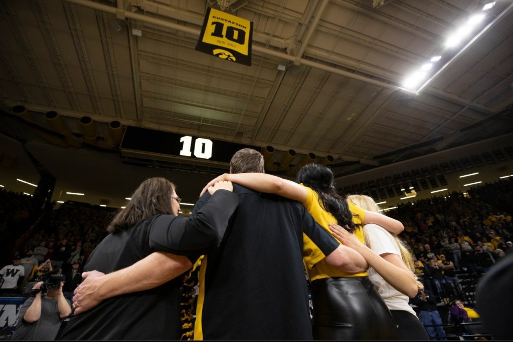 Megan Gustafson and her family watch as her No. 10 is raised into the rafters at Carver-Hawkeye Arena.