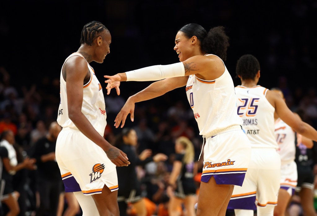 Satou Sabally (right) pushes Natasha Mack (left) in celebration