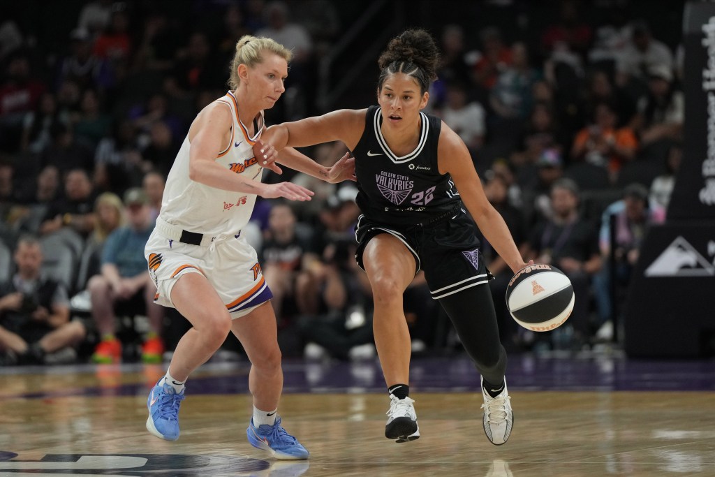 Golden State Valkyries guard Veronica Burton drives by Phoenix Mercury guard Lexi Held. She is shown from the front, dribbling the ball with her left hand.